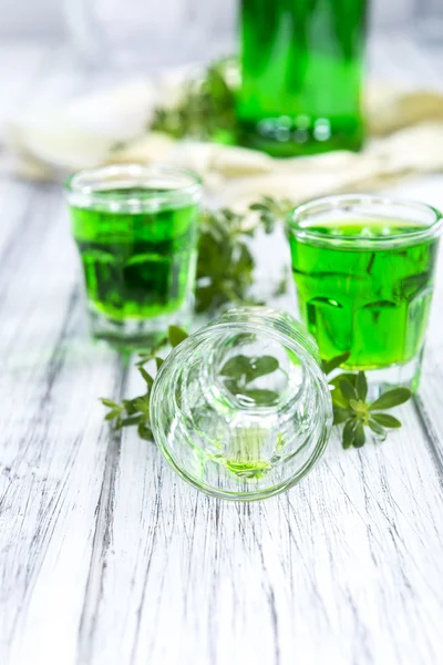 Woodruff Liqueur on a wooden table — Stock Photo, Image