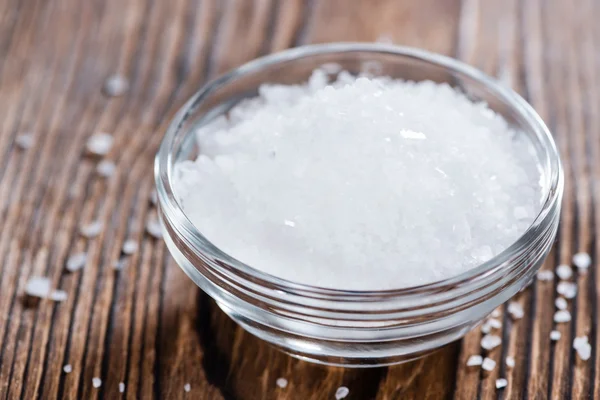 Portion of Salt on dark wooden background — Stock Photo, Image