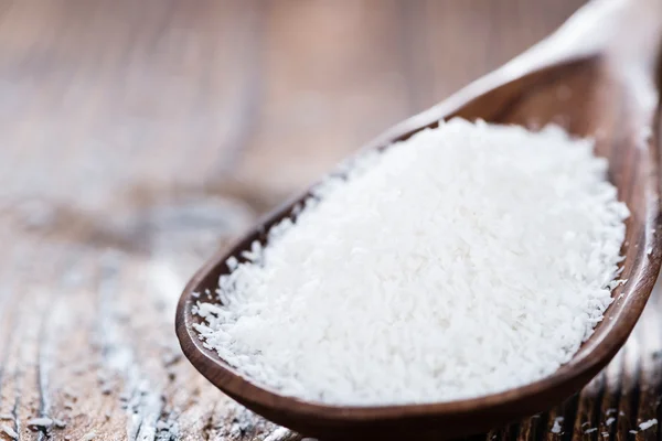 Grated Coconut on wooden background — Stock Photo, Image