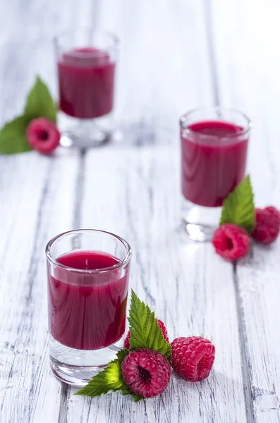 Raspberry Liqueur with some fresh fruits in a glass — Stock Photo, Image
