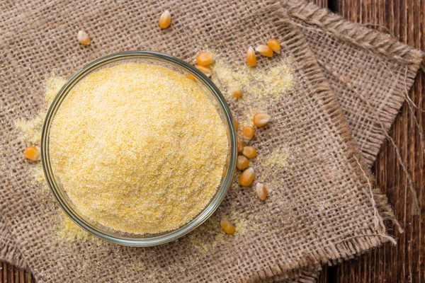 Portion of Cornmeal on wooden background — Stock Photo, Image