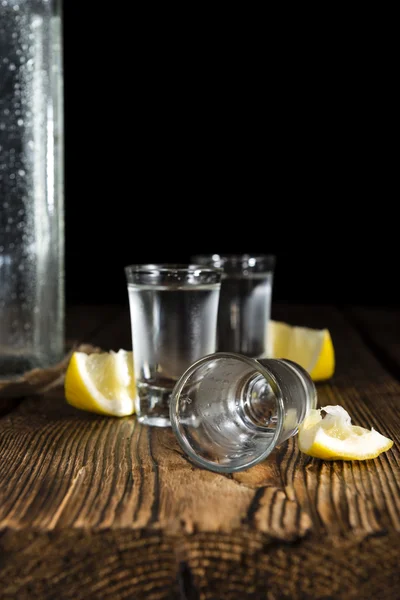 Pure Vodka on an old wooden table — Stock Photo, Image