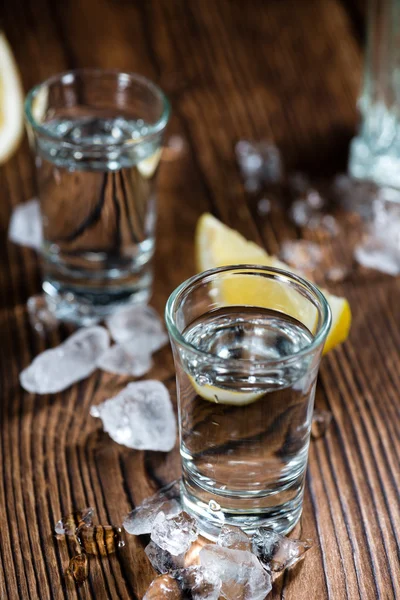 Pure Vodka on an old wooden table — Stock Photo, Image