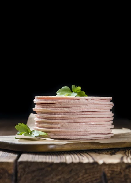 Mortadella Slices on wooden table — Stock Photo, Image