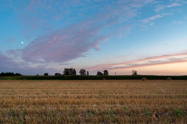 A stubble field and evening clouds after sunset, Nowiny, Poland