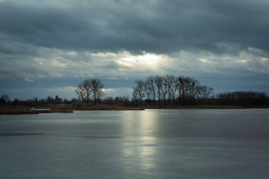 Stormy clouds over the frozen lake, Stankow, Lubelskie, Poland