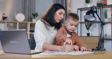 Diz çöküp güzel bir resim çizmesine yardım eden 30 yaşında bir kadının portresi.