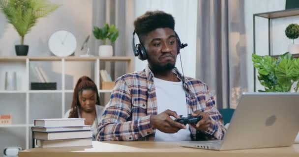 Cheerful black man playing games while woman caring for kid — Stock Video