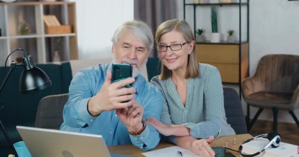 Leende mogna par med hjälp av smartphone för att ta selfie — Stockvideo