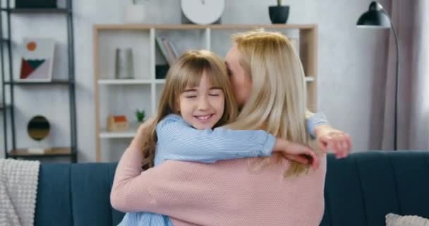 Beautiful happy smiling teen girl hugging with her lovely caring light-haired mother at home ,family relations concept — Stock Video