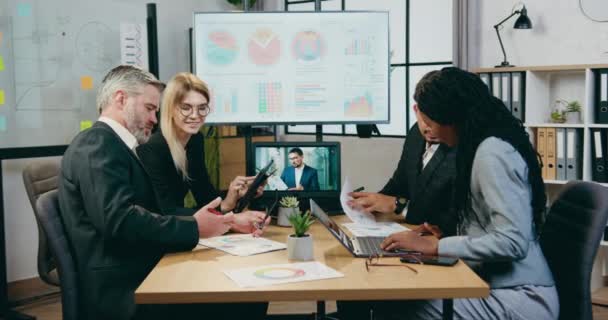 Beau motivé intelligent expérimenté mixte hommes d'affaires brainstorming ensemble sur la stratégie d'entreprise dans la salle de conférence moderne lors de la réunion — Video