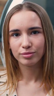 Closeup portrait of attractive blond woman with natural makeup with perfect wrinkled face skin care spa procedures looking at camera in bathroom. Slow motion.