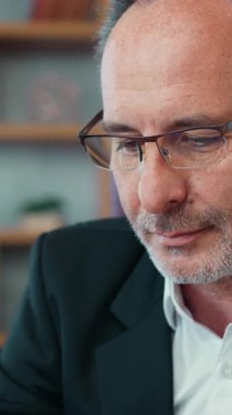 Likable purposeful skilled successful bearded businessman in formal wear in glasses working on laptop in beautifully designeted office room,business concept