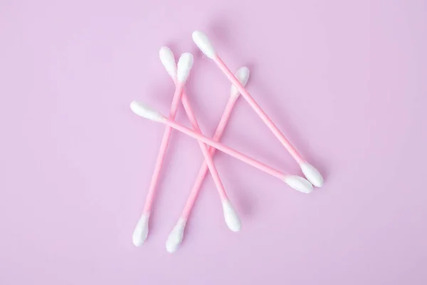 Cotton swabs isolated on pink background. Beauty and hygiene concept