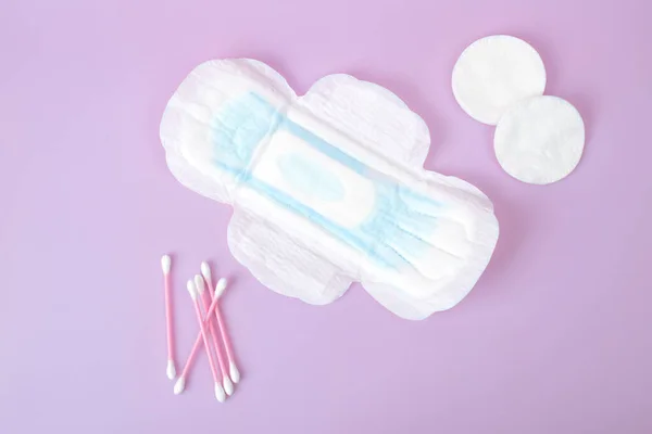 Sanitary pad, Cotton swab and cotton pad isolated on pink background. Beauty and hygiene concept