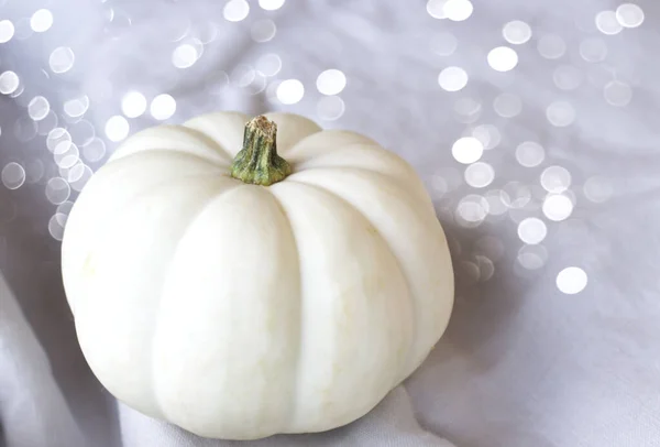Modern autumn styled composition with white pumpkins and silver sparkling bokeh lights. Halloween, Thanksgiving party concept. Festive fall design. — Stock Photo, Image