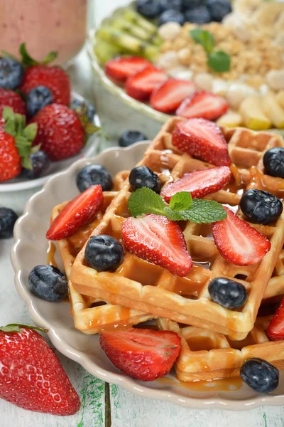 Waffles with berries and caramel sauce — Stock Photo, Image