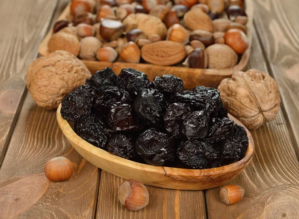 Dried prunes in a wooden bowl