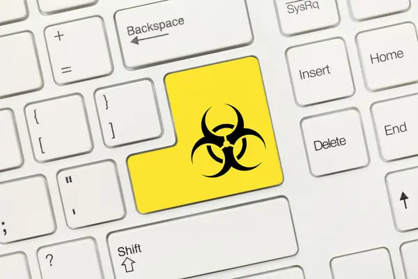 Papan tik konseptual putih - tombol kuning dengan simbol biohazard — Stok Foto