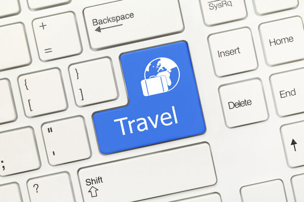 Close-up view on white conceptual keyboard - Travel (blue key)