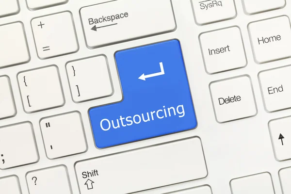 Witte conceptuele toetsenbord - Outsourcing (blauwe toets) Stockfoto