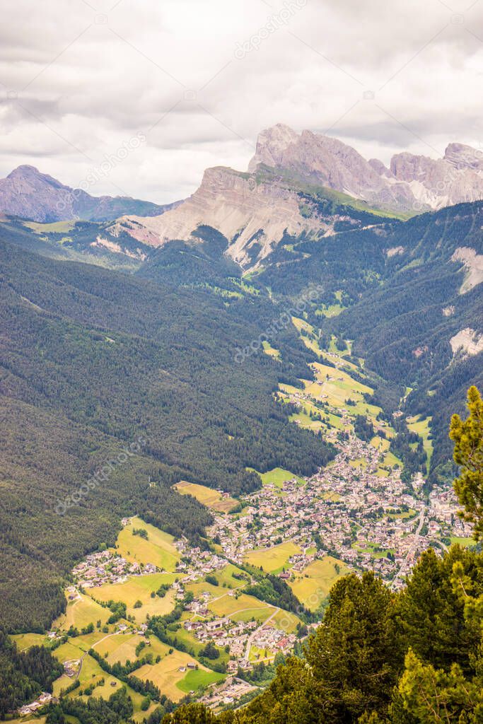 Alpe di Siusi, Seiser Alm with Sassolungo Langkofel Dolomite, a close up of a lush green field in a valley canyon