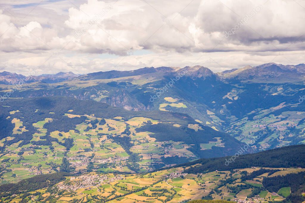 Italy, Alpe di Siusi, Seiser Alm with Sassolungo Langkofel Dolomite, a view of a large mountain in the background