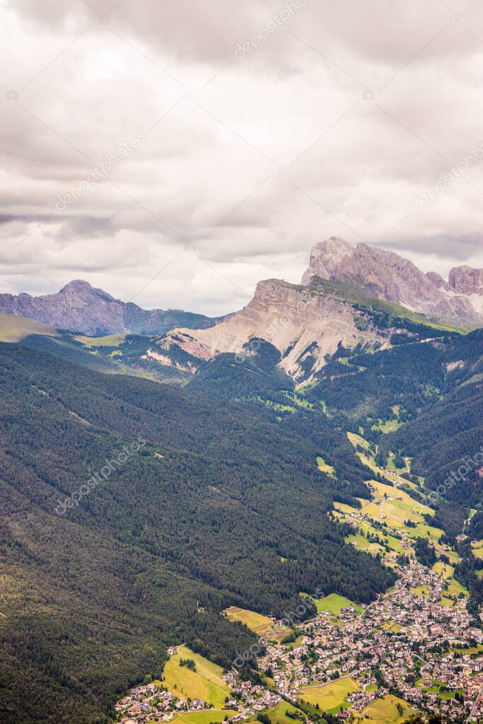 Alpe di Siusi, Seiser Alm with Sassolungo Langkofel Dolomite, a close up of a lush green field in a valley canyon