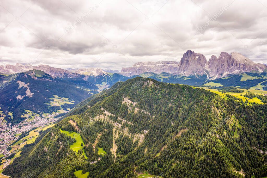 Italy, Alpe di Siusi, Seiser Alm with Sassolungo Langkofel Dolomite, a large mountain in the background