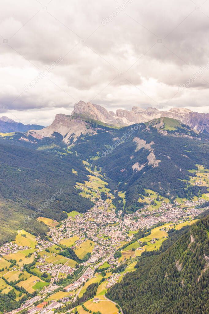 Alpe di Siusi, Seiser Alm with Sassolungo Langkofel Dolomite, a close up of a lush green field in a valley canyon