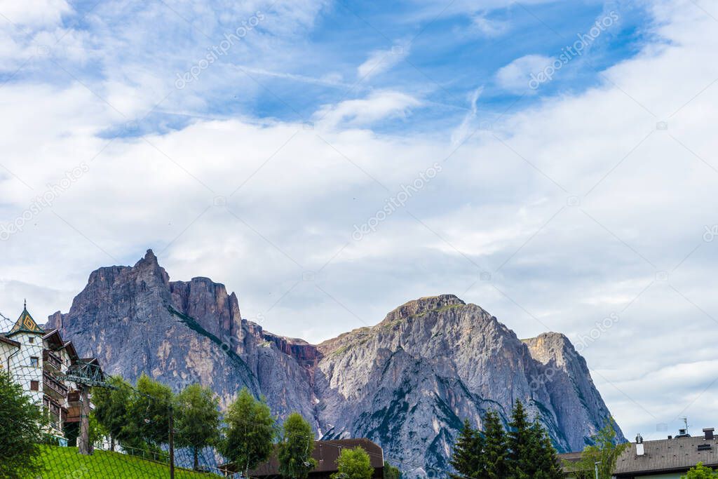 Italy, Alpe di Siusi, Seiser Alm with Sassolungo Langkofel Dolomite, a large mountain in the background