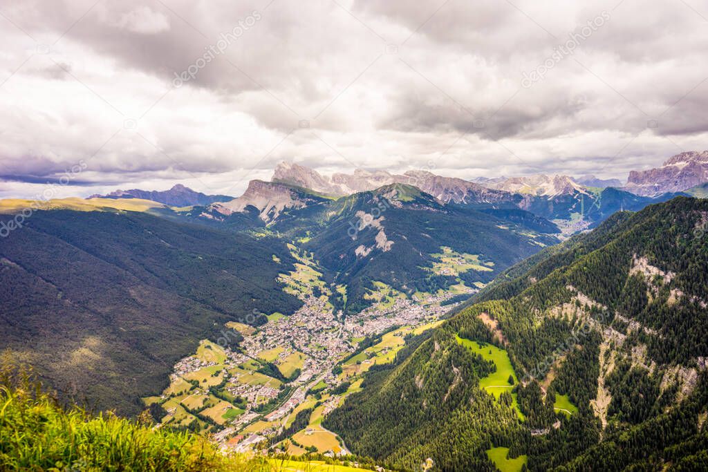 Italy, Alpe di Siusi, Seiser Alm with Sassolungo Langkofel Dolomite, a view of a large mountain in the background