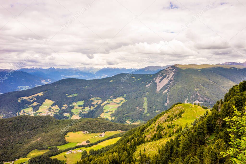 Italy, Alpe di Siusi, Seiser Alm with Sassolungo Langkofel Dolomite, a view of a large mountain in the background