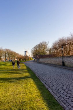 Belçika, Bruges, yel değirmeni olan bir grup insan.