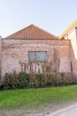 Avrupa, Belçika, Bruges, çimenli ve ağaçlı büyük bir tuğla bina