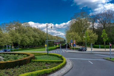 BRÜKSEL, BELGIUM - 17 Nisan 2017: Brüksel, Belçika sokaklarındaki bir bahçenin önünden bir araba geçiyor