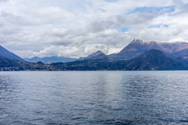 Avrupa, İtalya, Varenna, Como Gölü. Arkasında dağ olan büyük bir su kütlesi.