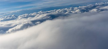 Uçak penceresinden bulutların görüntüsü, gökyüzünde bir grup bulut.