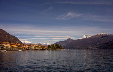 Avrupa, İtalya, Menaggio, Como Gölü. Arkasında dağ olan büyük bir su kütlesi.