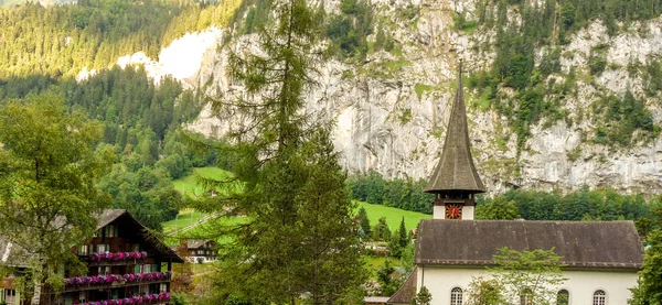 Switzerland, Lauterbrunnen, Europe,  HOUSE AMIDST TREES AND BUILDINGS IN CITY