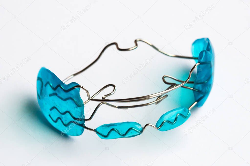 orthodontic blue retainer isolated on white background.