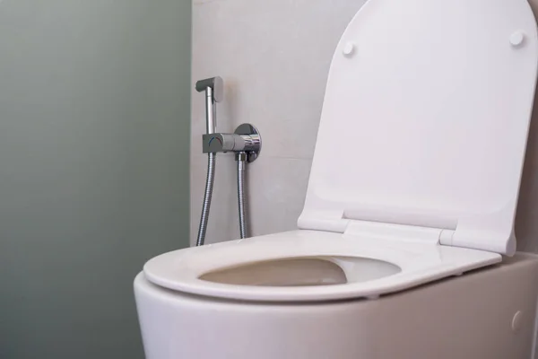 Hygienic shower spray near the toilet for care — Stock Photo, Image