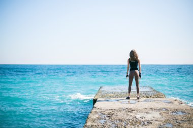 Daha önce eğitim Deniz kenarındaki iskelede atletik kadın