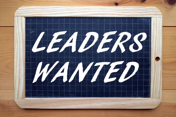 The words Leaders Wanted in white text on a blackboard — Stock Photo, Image