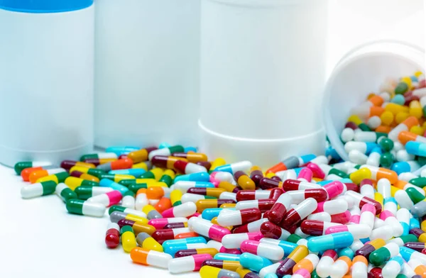 Heap of antibiotic capsule with plastic bottle. Antibiotic drug resistance concept. Antibiotic drug overuse and smart use concept. Pharmaceutical industry. Pharmacy product. Prescription drugs.