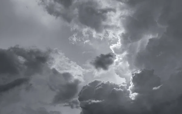 Dark dramatic sky and clouds. Background for death and sad concept. Gray sky and fluffy white clouds. Thunder and storm sky. Sad and moody sky. Nature background. Dead abstract background. Cloudscape.