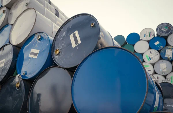 Old chemical barrels. Blue oil drum. Steel chemical tank. Toxic waste warehouse. Hazard chemical barrel. Industrial waste drum. Hazard waste storage in factory. Hazardous and toxic waste barrel.