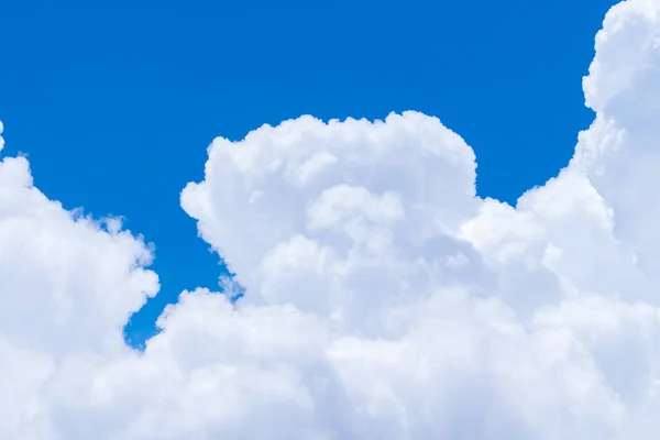 White fluffy clouds on blue sky. Soft touch feeling like cotton. White puffy cloudscape. Beauty in nature. Close-up white cumulus clouds texture background. Sky on sunny day. Pure white clouds.