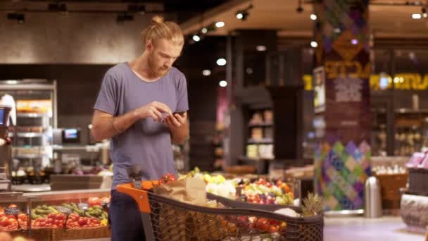 Çekici Sarışın Sakallı Bir Adam Arabası Mal Dolu Modern Süpermarkette — Stok video