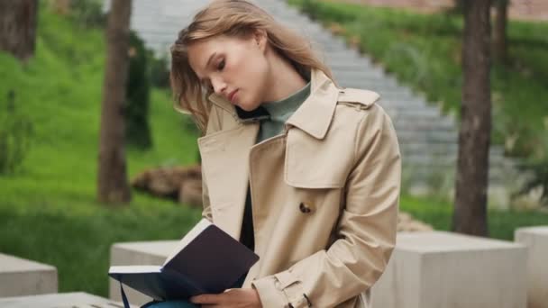 Attractive Student Girl Talking Phone While Reading Book Preparing Exams — Stock Video